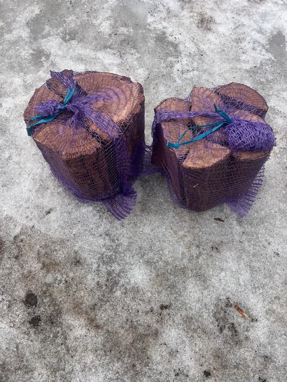 Two net bags of split firewood