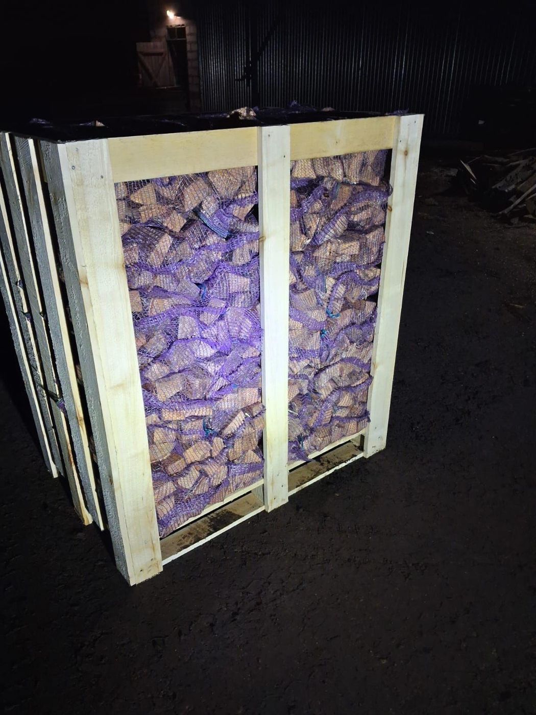 Crate filled with firewood net bags