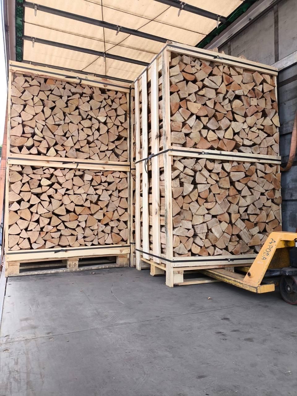 Crates of firewood loaded inside a curtain-side truck