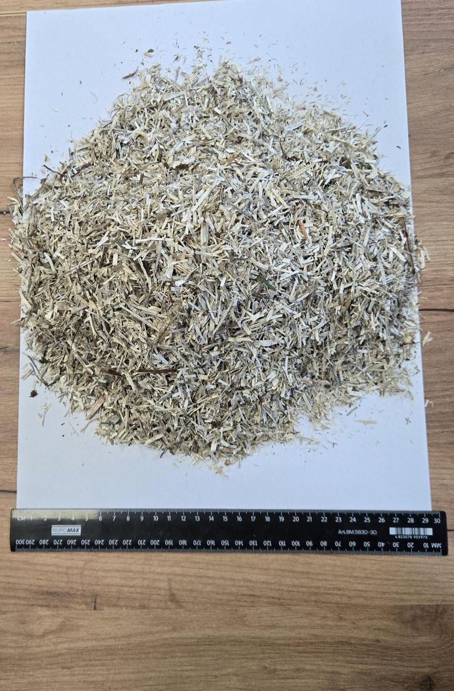 Loose hemp bedding for horses next to a ruler